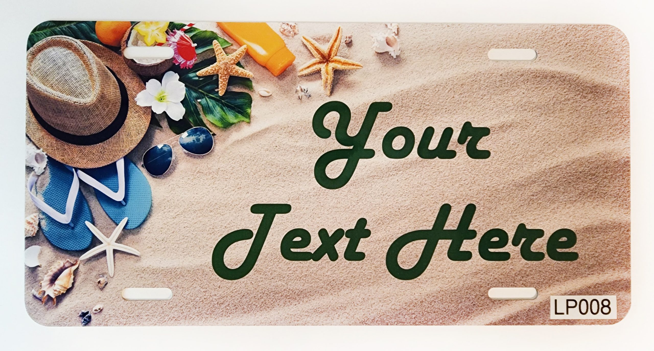 A beach scene with sand, shells and flowers.