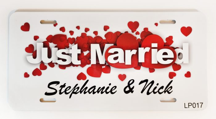 A just married sign with red hearts on it.