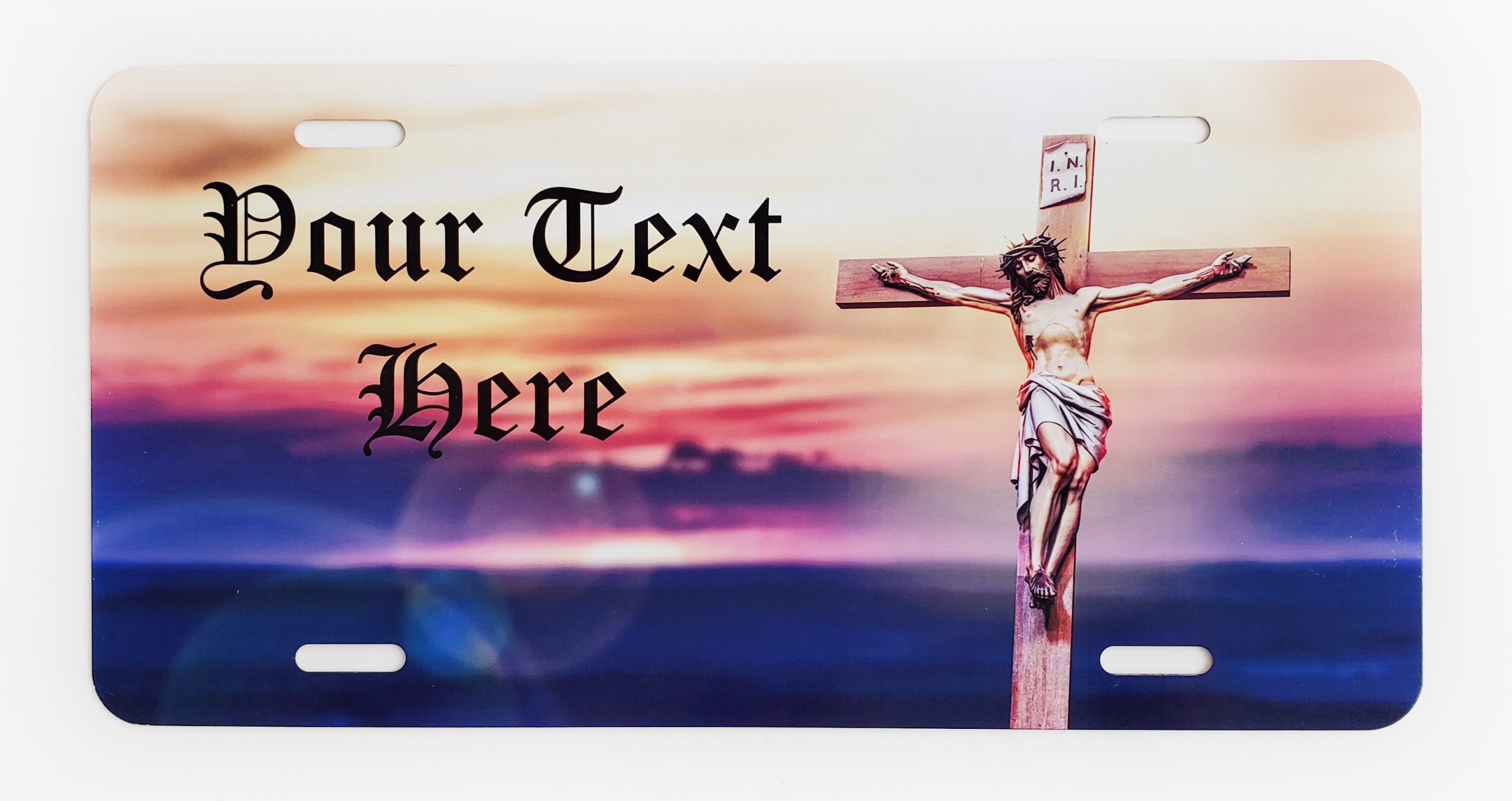 A picture of jesus on the cross with sunset in background.