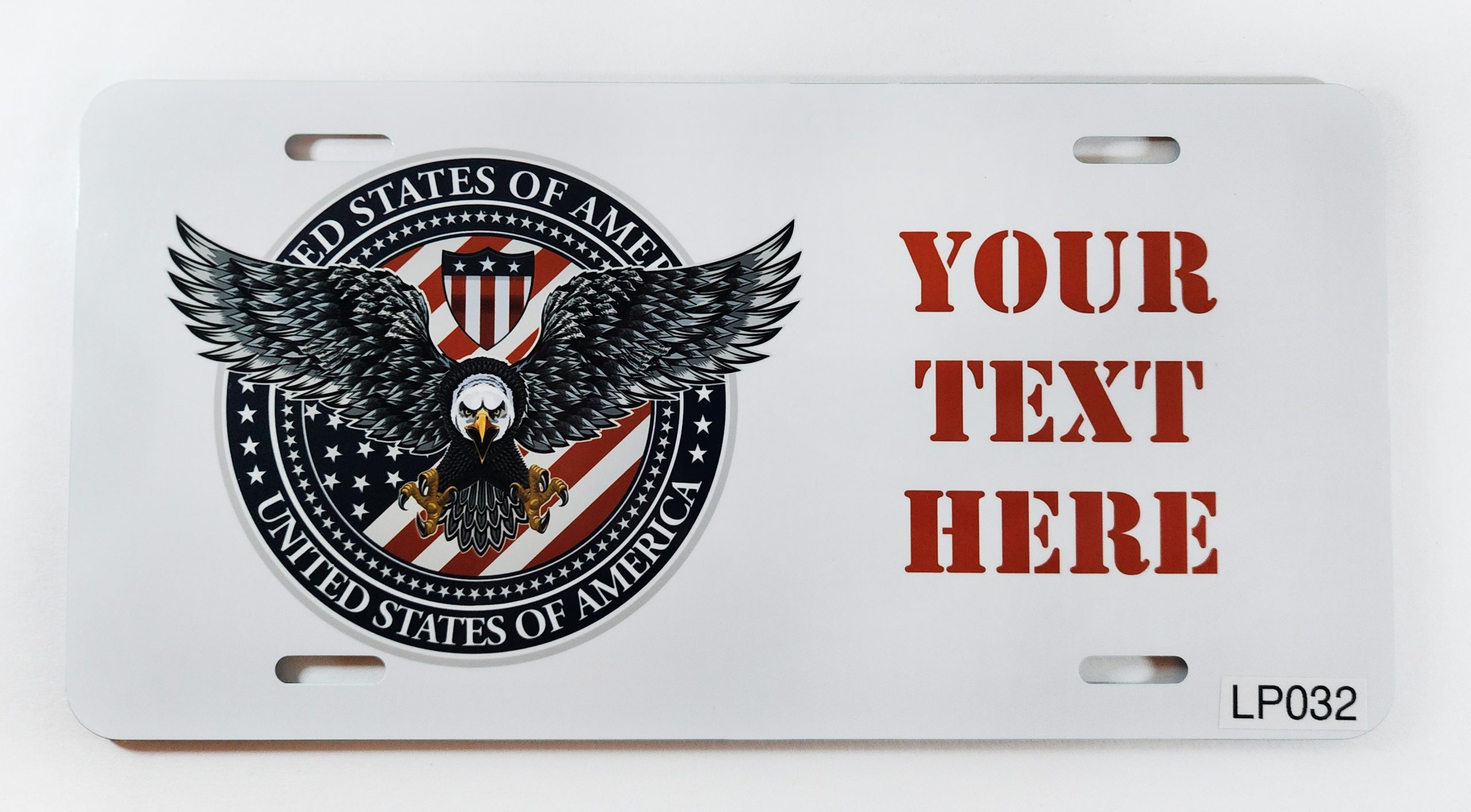 A white license plate with an eagle and american flag on it.