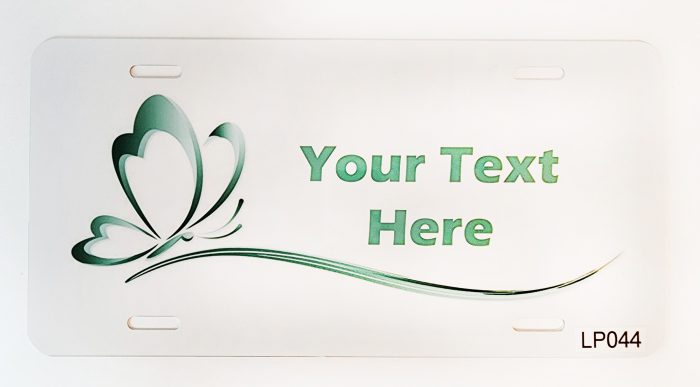 A white plate with green swirls and text.