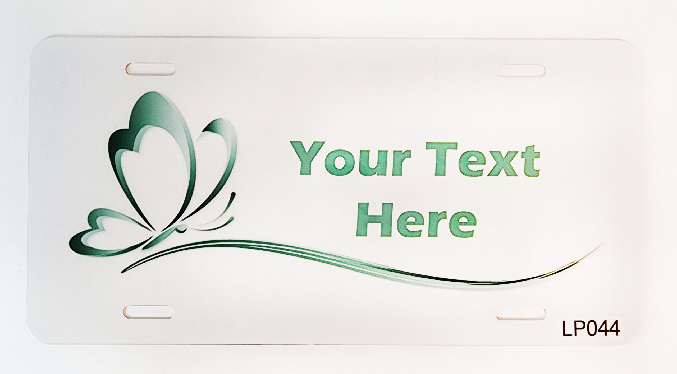 A white plate with green swirls and text.