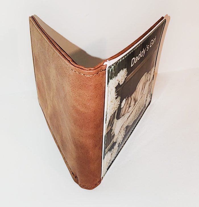 A brown leather wallet with a picture of a woman.