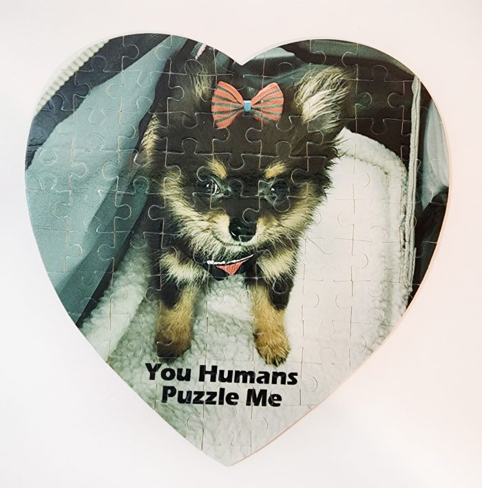 A heart shaped puzzle with a picture of a dog.