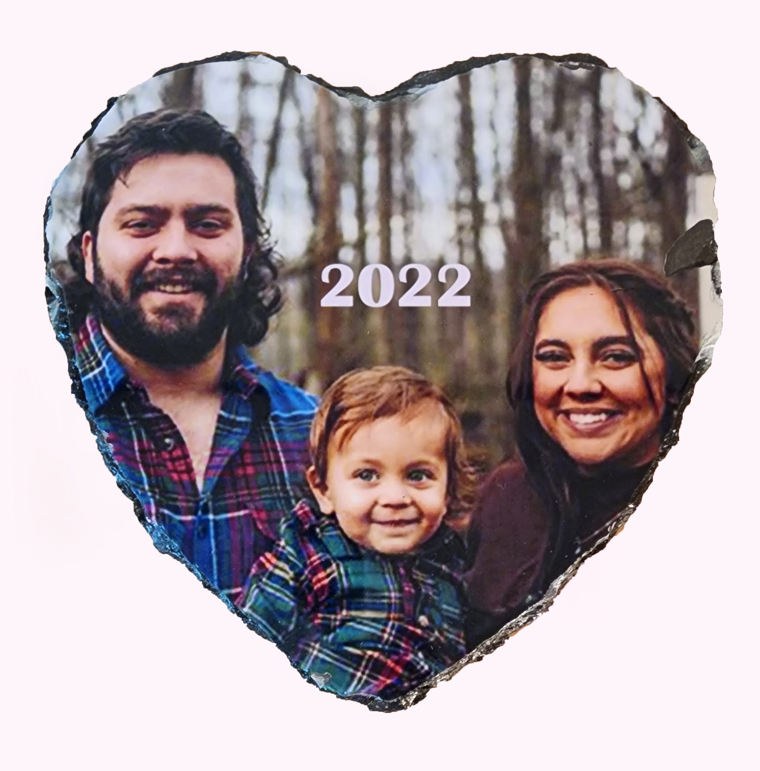 A couple and their child are posing for the camera.