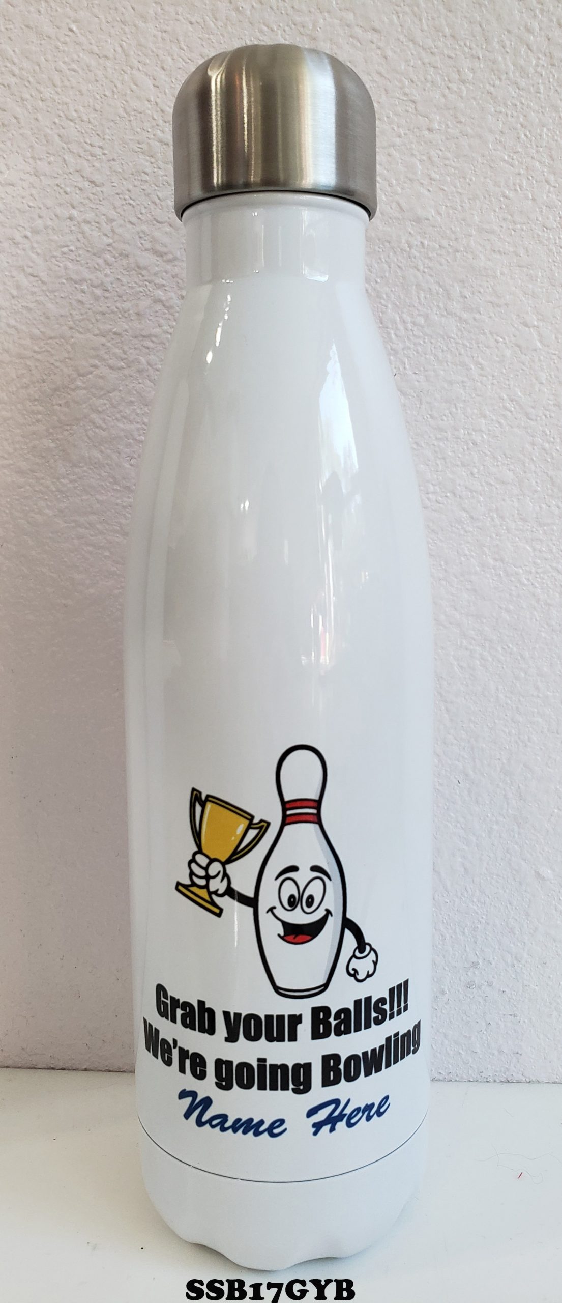 A white bottle with bowling and trophy on it.