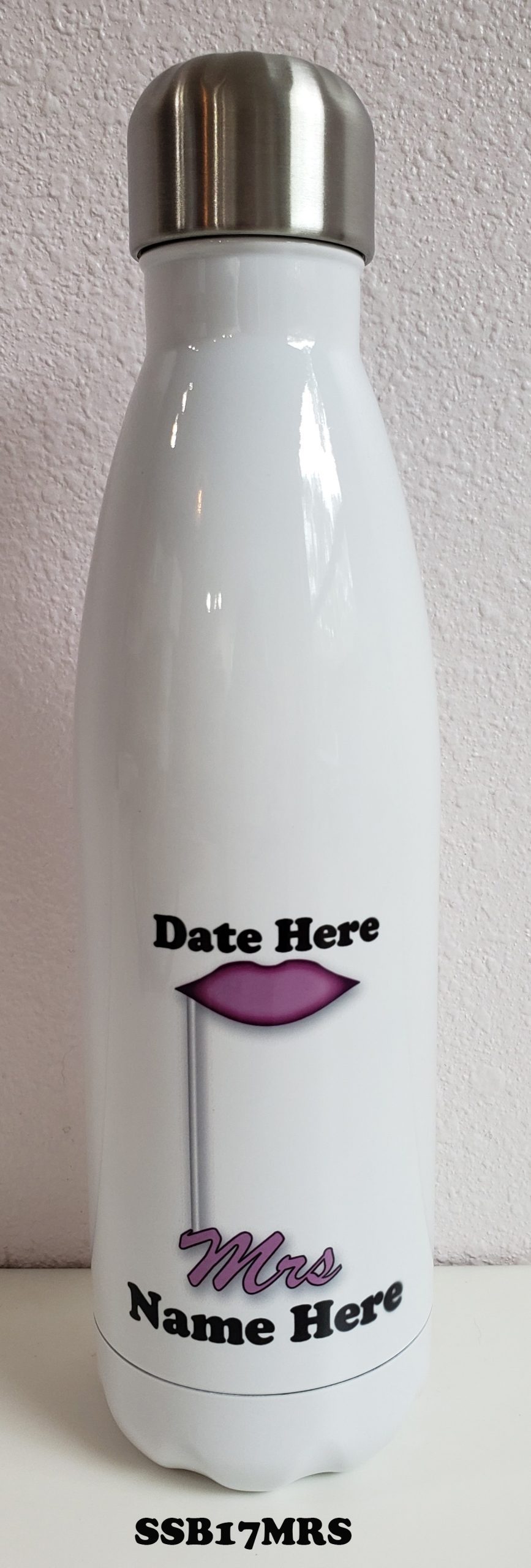 A white bottle with a purple lip and date here written on it.