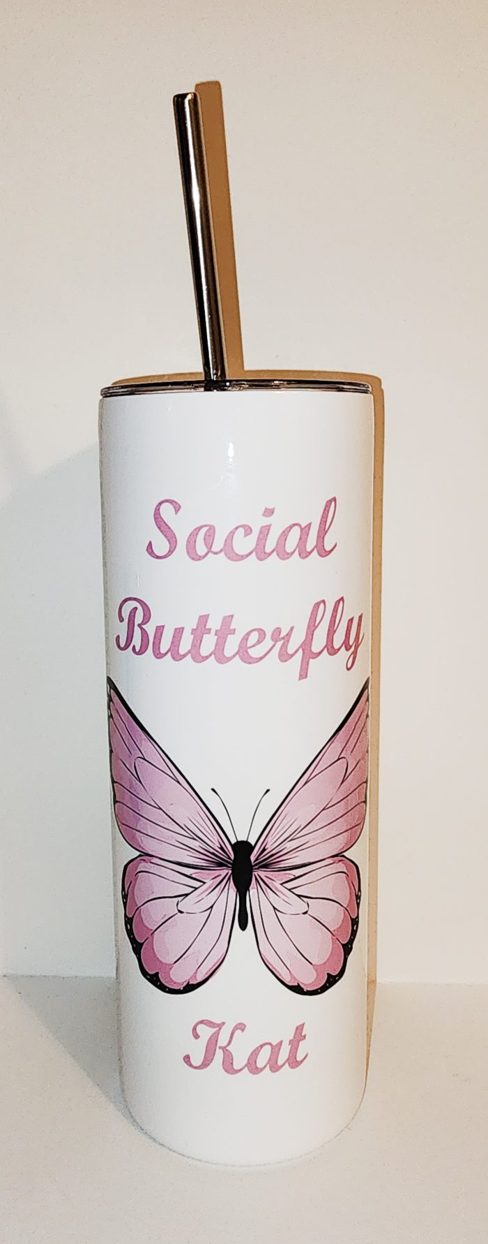 A pink butterfly is on the side of a white background.