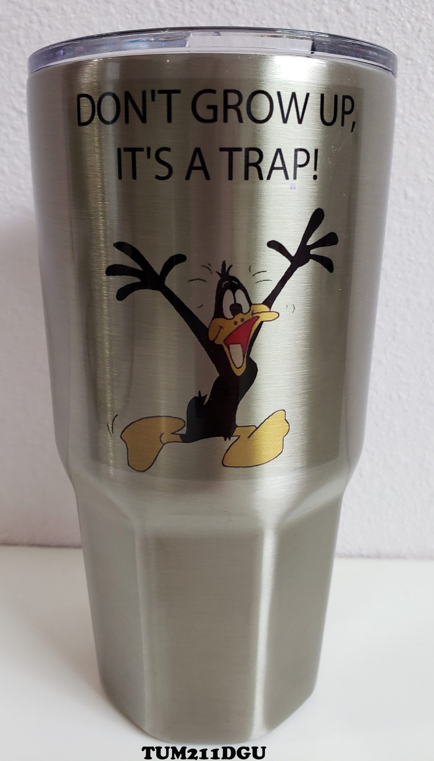 A stainless steel cup with a picture of daffy duck.