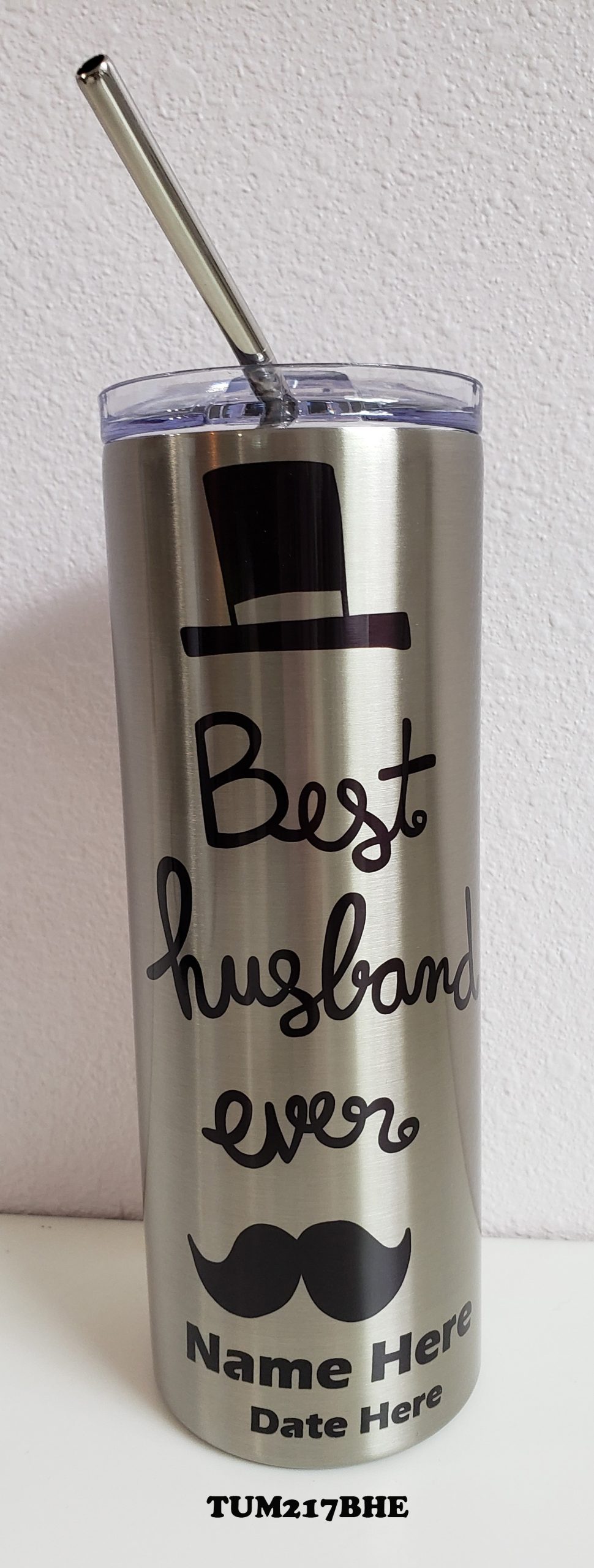 A silver cup with the words " best husband ".