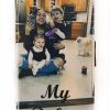 A woman and two children taking a picture with their cell phone.