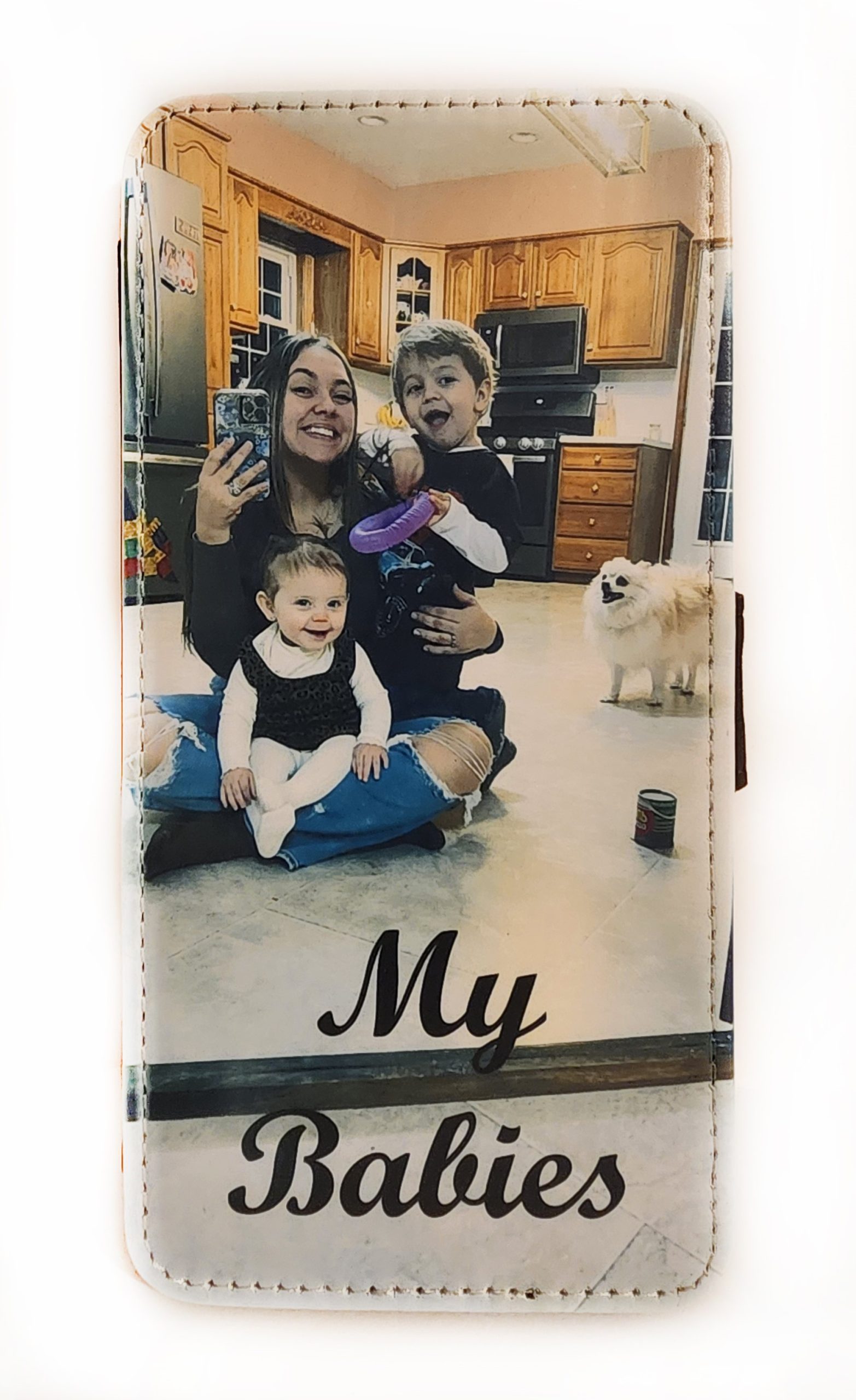 A woman and two children taking a picture with their cell phone.