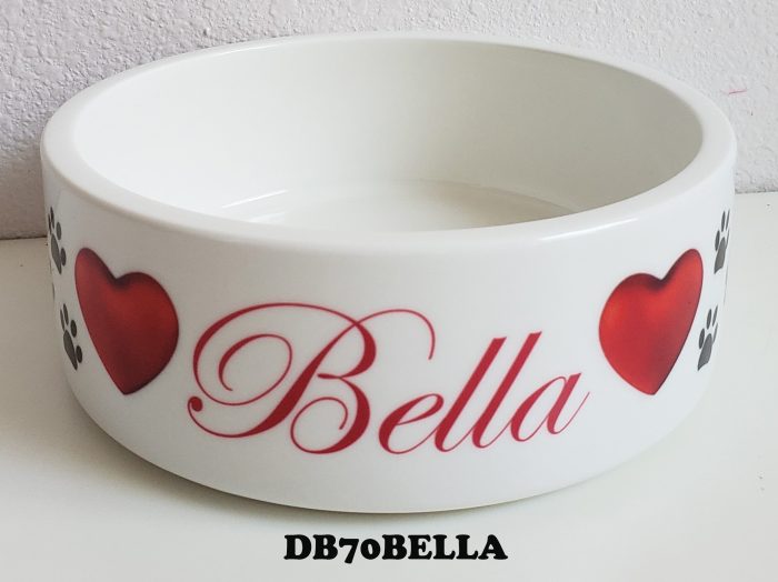 A bowl with red hearts and the name " bella ".