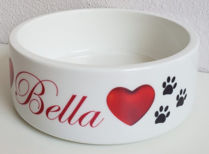 A bowl with the name of bella and paw prints.