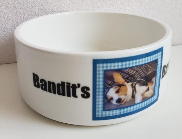 A bowl with a picture of a dog and the name bandit 's.