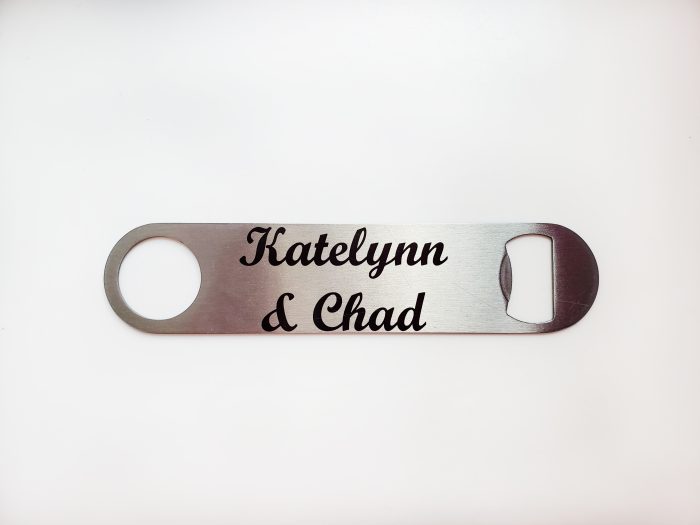 A bottle opener with the name of a couple.