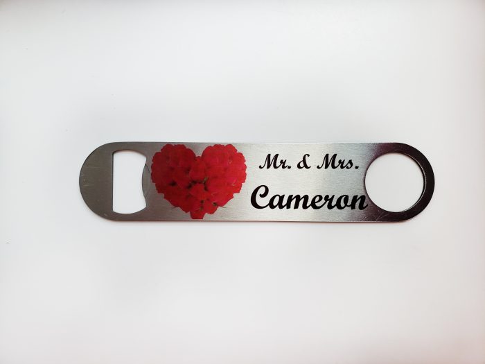 A bottle opener with the name of the couple and a heart.