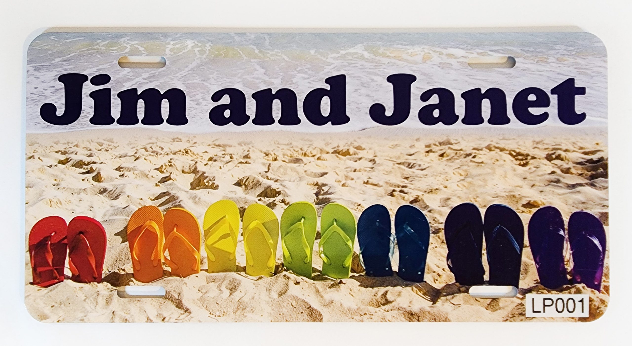 A row of colorful flip flops on the beach.