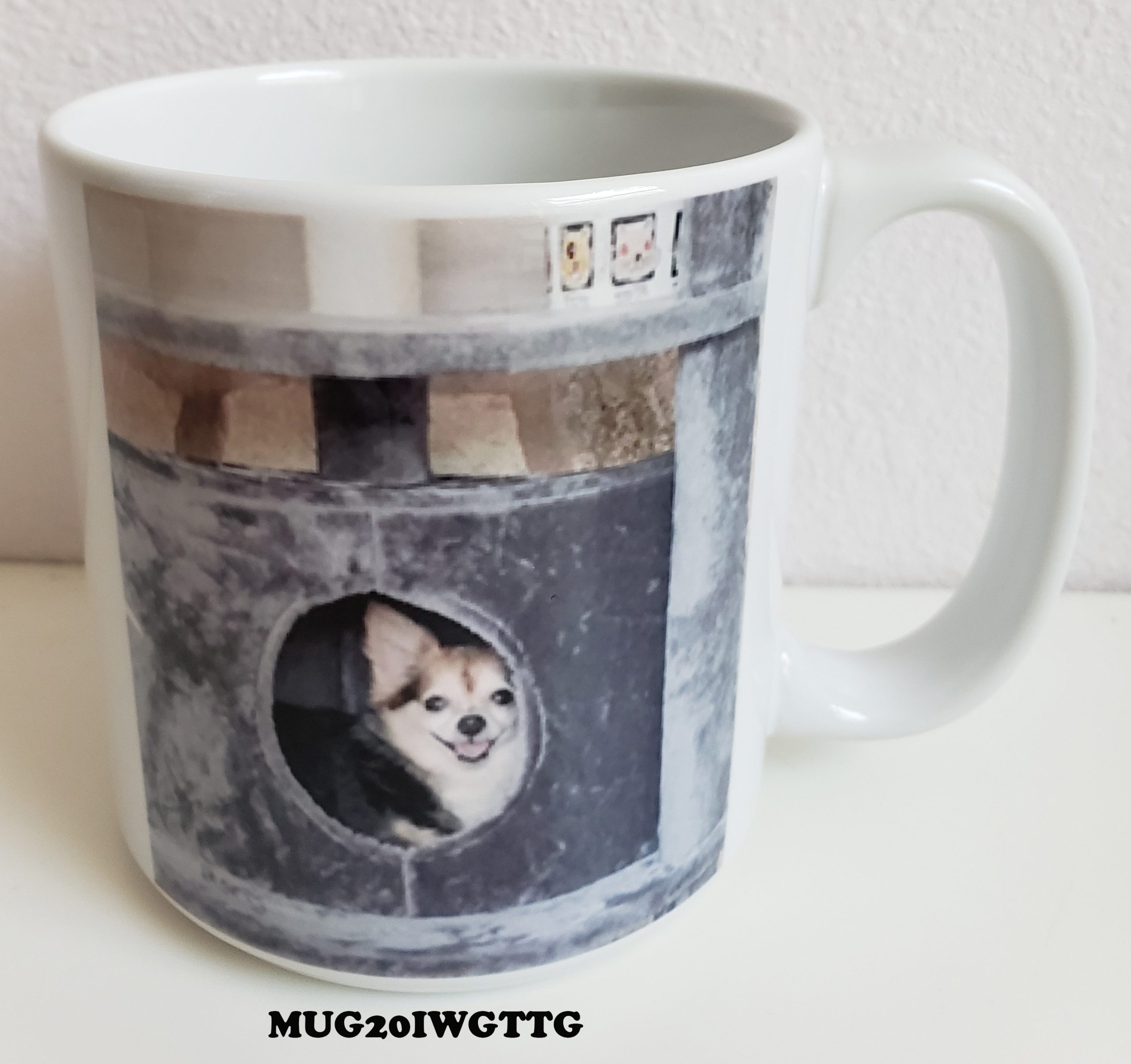 A mug with a picture of a dog in a window.