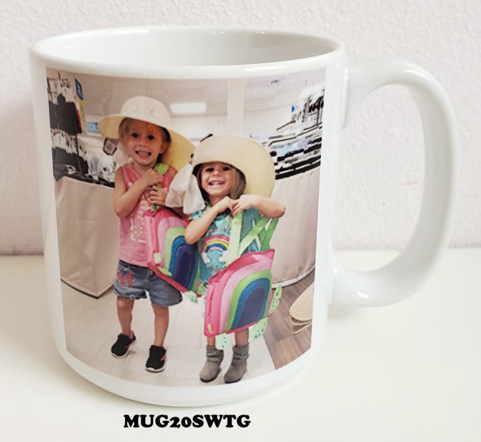 A mug with two girls holding hands and one girl is wearing a hat.