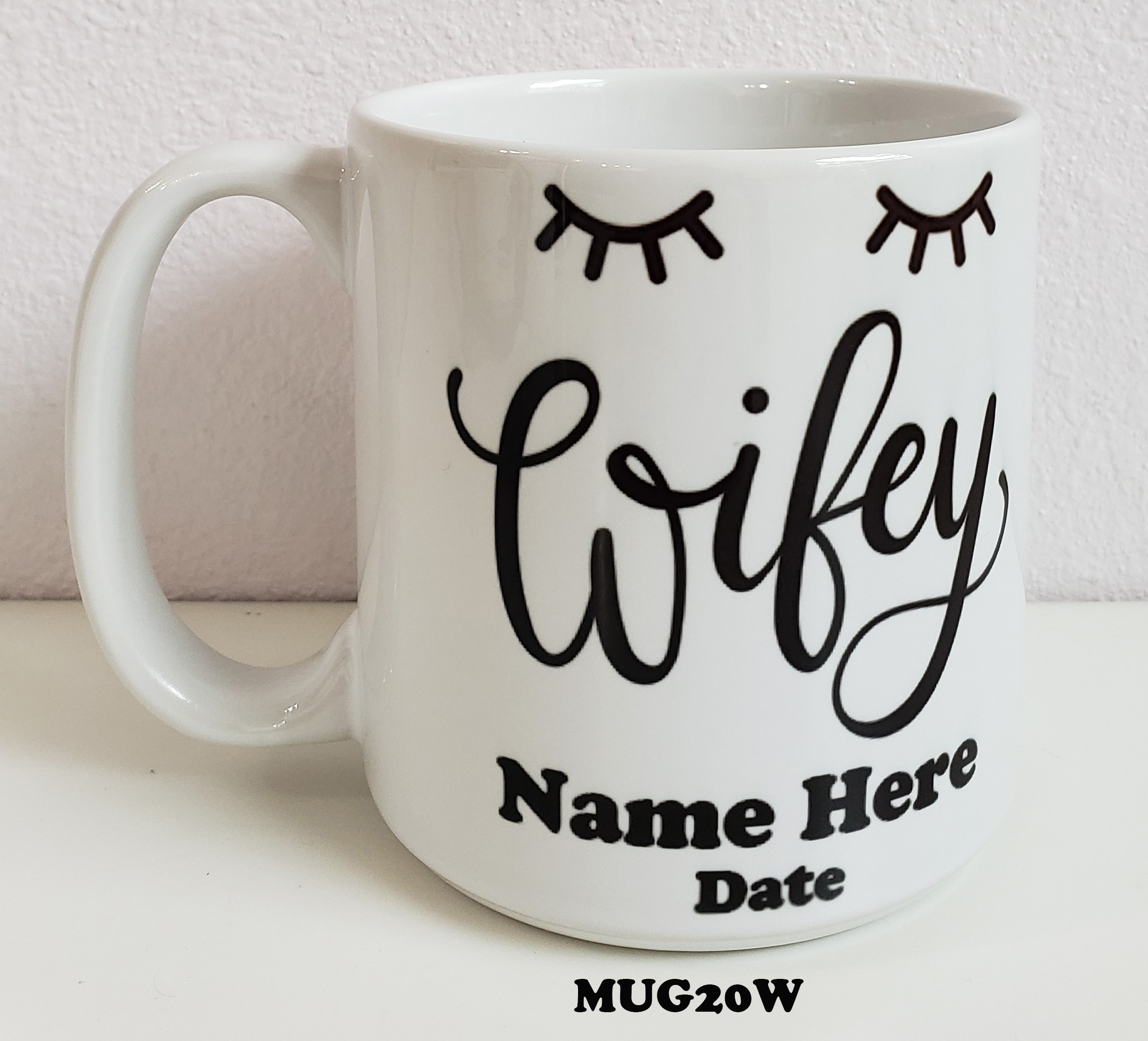 A mug that says wifey and has eyelashes on it.