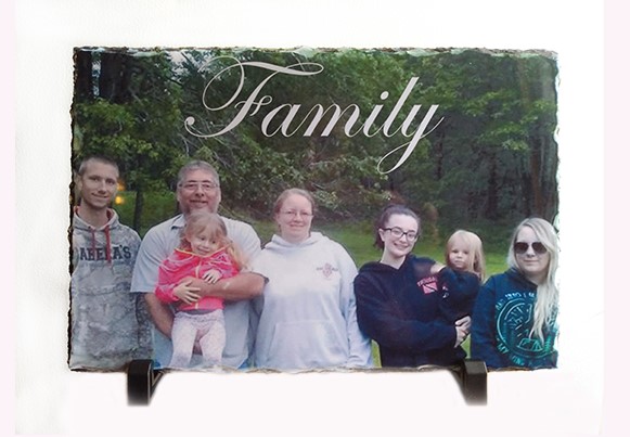 A family photo is displayed on a plaque.