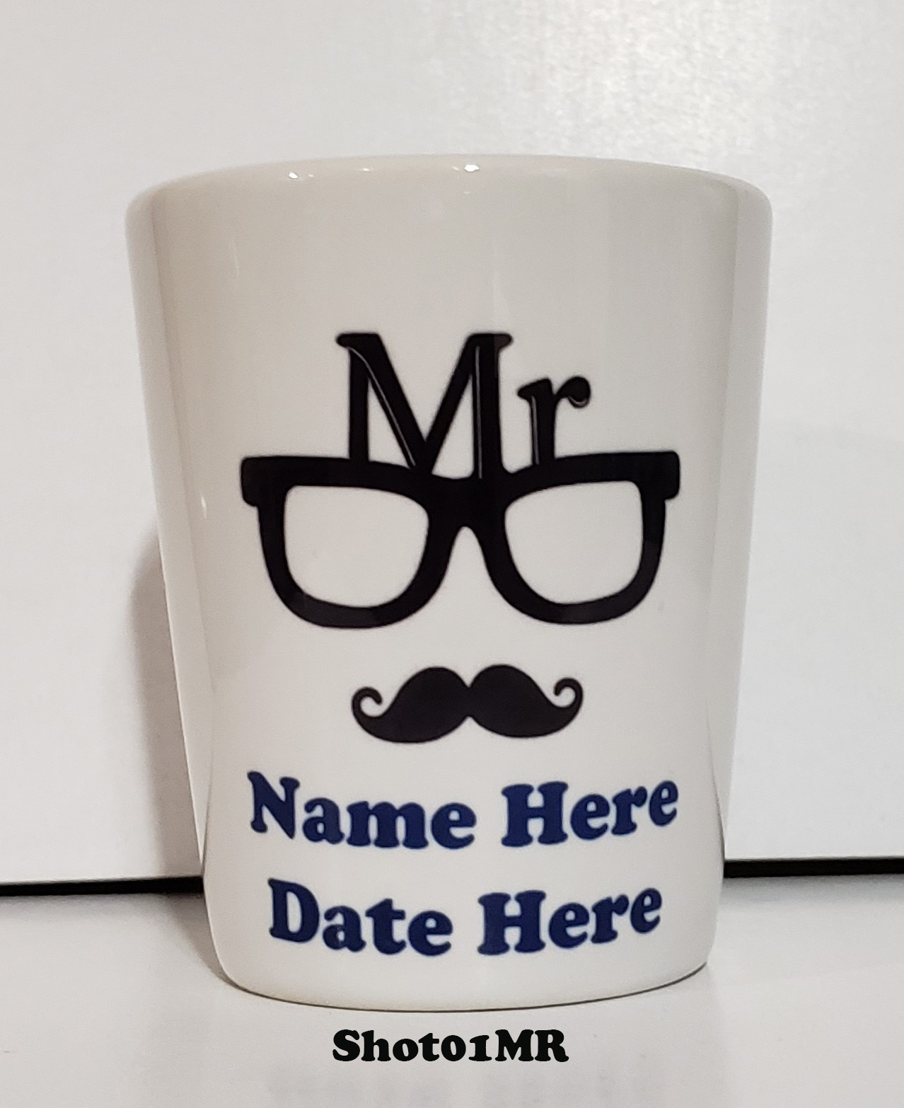 A mug with the name, date and location of the cup.