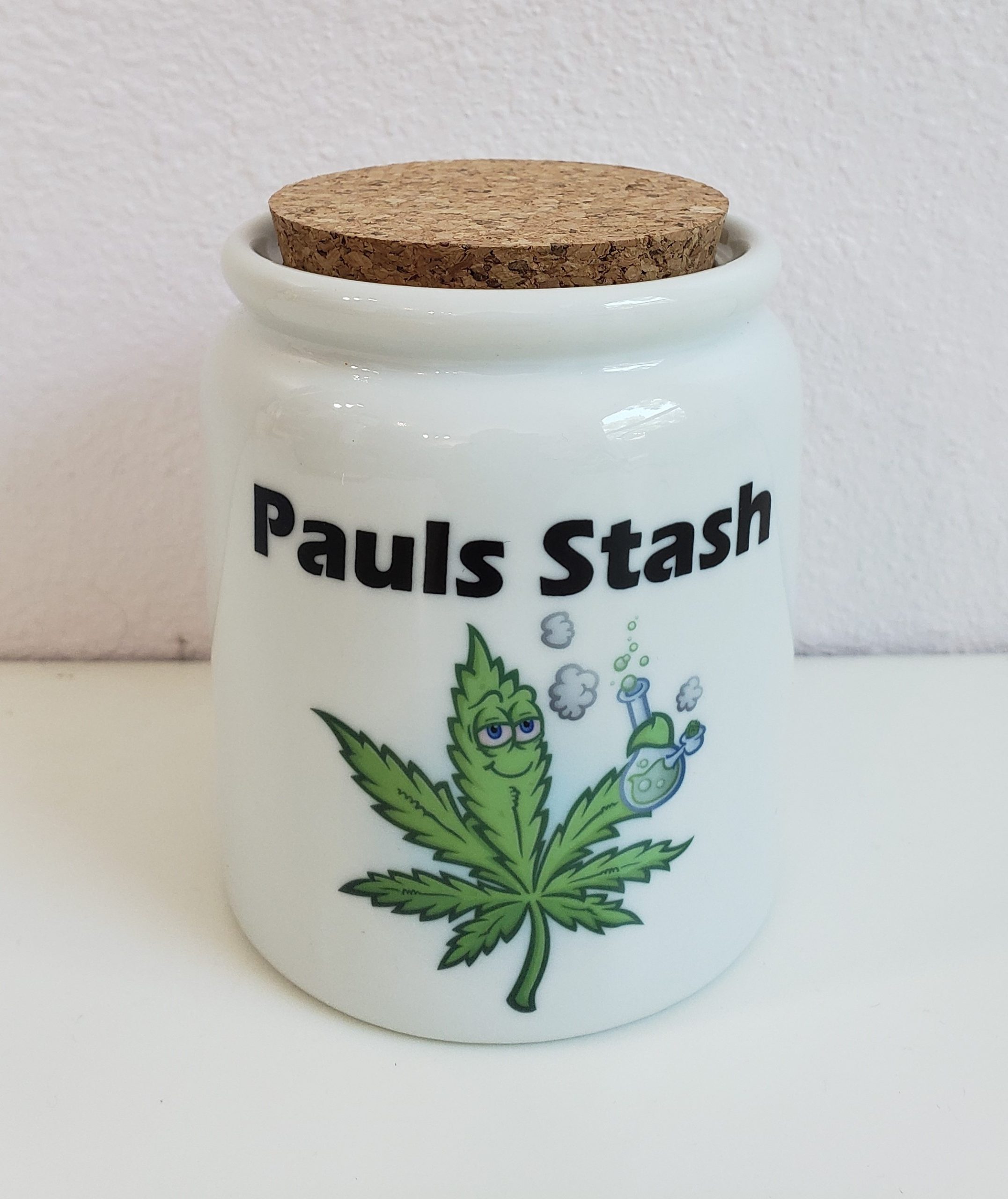 A jar with the name of a person and a picture of a leaf.