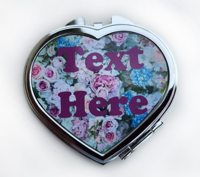 A heart shaped compact mirror with the words " text here ".