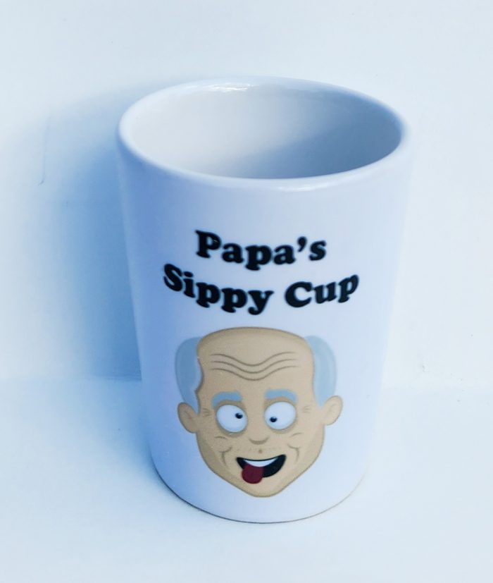 A cup with an image of a man 's face on it.